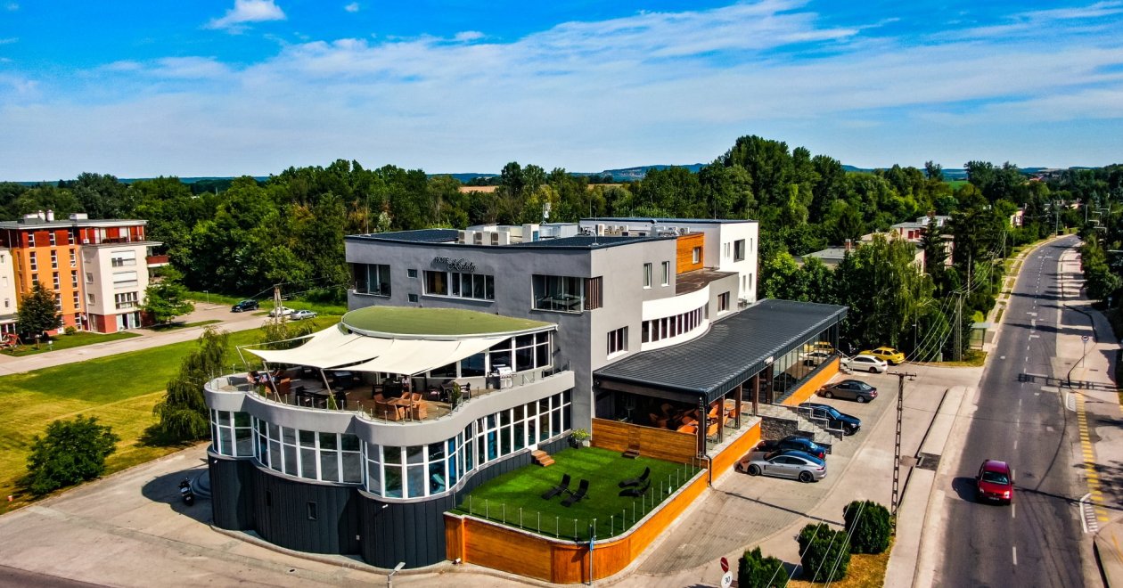 Why is it important for a business hotel to offer more than accommodation?